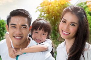 Family smiling together after scheduling a dental appointment
